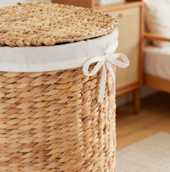 Half-moon woven laundry basket with lid, includes removable lining and handle, suitable for bathroom or bedroom use, natural color